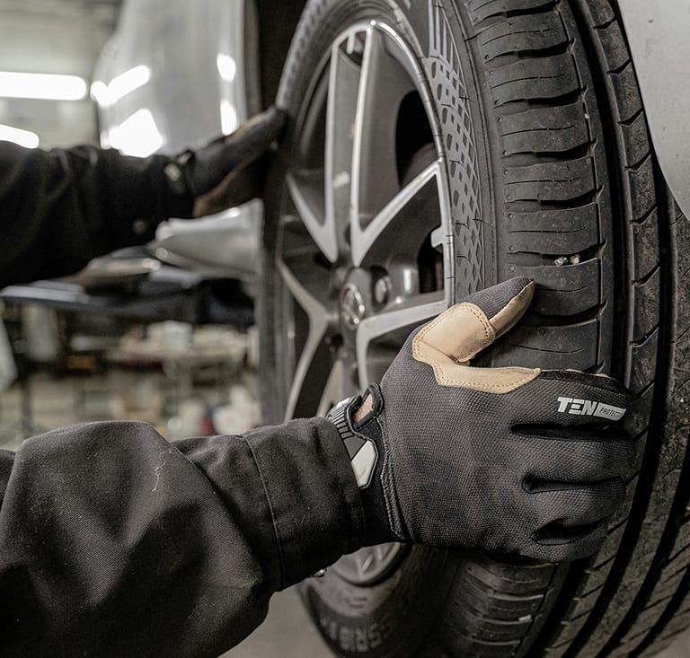 man securing tyre onto wheel